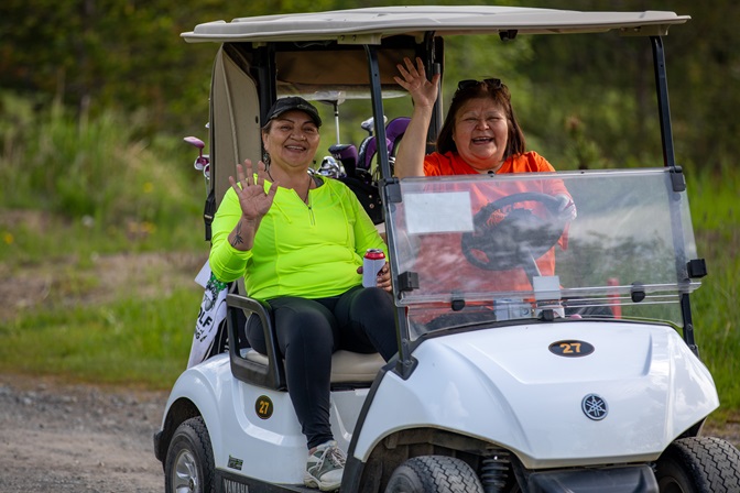 Golf scramble attendees in a golf cart