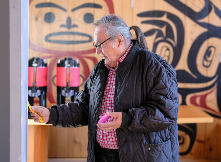 Dene'Tum prepares a wall for the student art exhibit. 