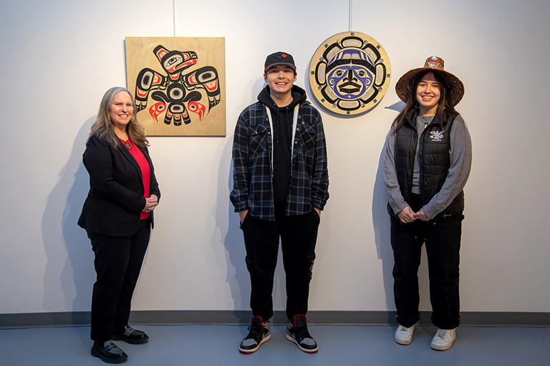 2025 President's Choice Award Winner, Elijah Morberg, and Hounourable Mention, Kashka Clellamin, with President Dr. Laurie Waye