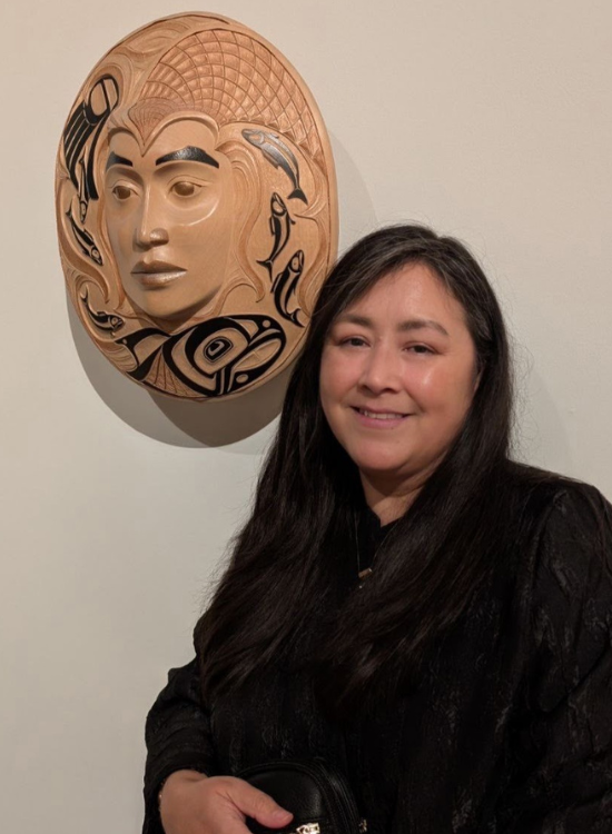 Arlene Ness with her carved mask. 