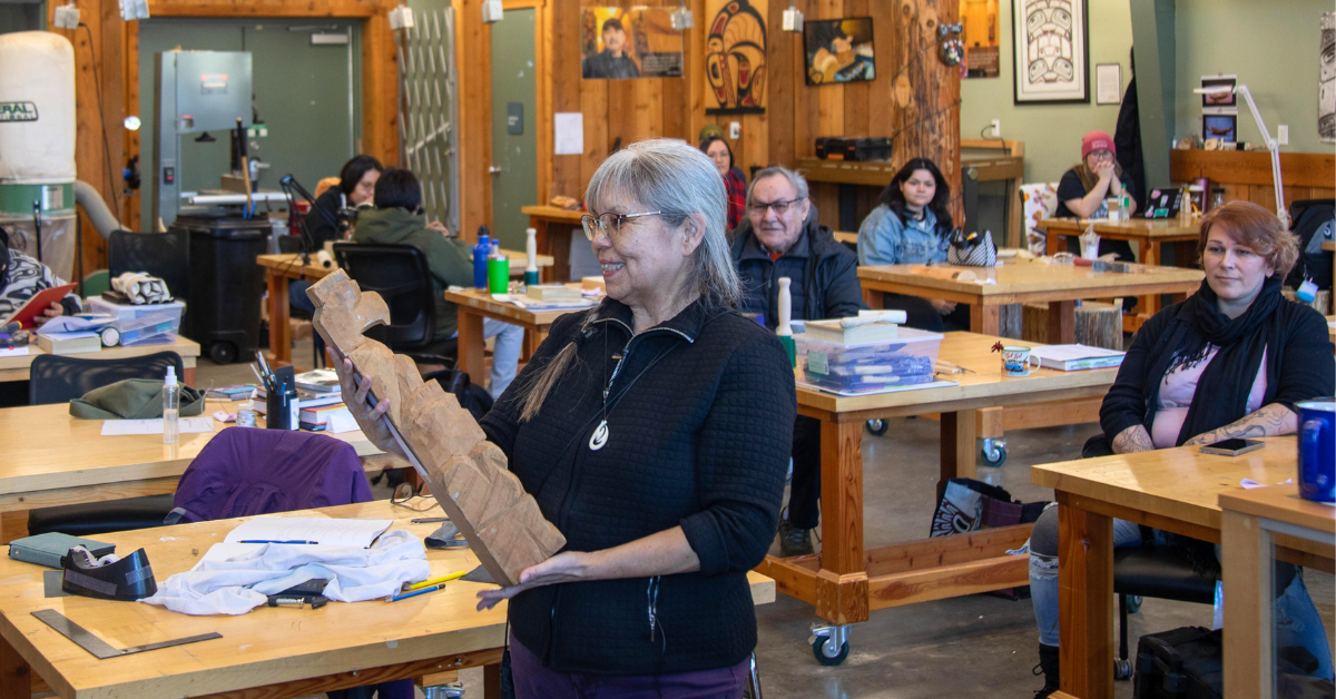 Lou-ann in the Freda Diesing studio accepting the totem pole